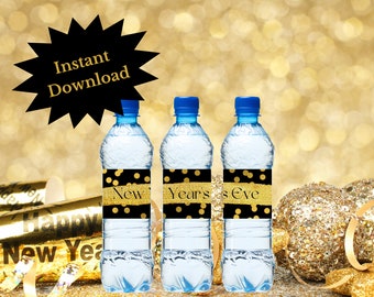 May include: Three clear plastic water bottles with black and gold labels that say "New Years Eve". The labels have gold glitter and gold polka dots. The bottles are on a gold background.