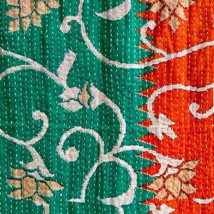 May include: A kantha quilt with a green and orange floral pattern. The quilt is made of cotton and has a hand-stitched design.
