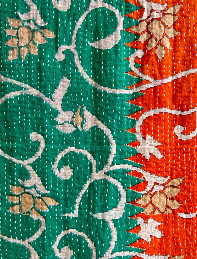 May include: A kantha quilt with a green and orange floral pattern. The quilt is made of cotton and has a hand-stitched design.