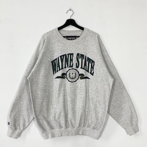May include: A gray Wayne State University sweatshirt with the university name in green lettering across the chest. The sweatshirt has a crew neck and long sleeves. The university logo is centered below the text.