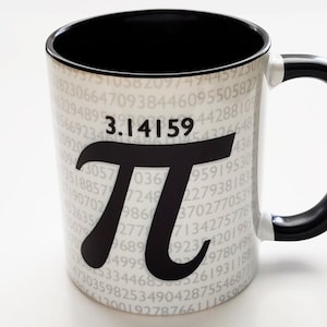 May include: A white ceramic mug with a black handle. The mug has a black and white design featuring the mathematical constant pi, 3.14159, and a background of repeating digits.