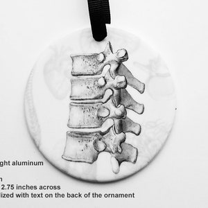 May include: A black and white anatomical illustration of a human spine on a round, white ornament. The ornament is 2.75 inches across and is available in light weight aluminum or porcelain.