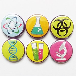 May include: Six colorful science themed buttons with purple borders. The buttons feature a green atom, a green beaker, a black biohazard symbol, a blue DNA strand, two green and red test tubes, and a gray microscope.