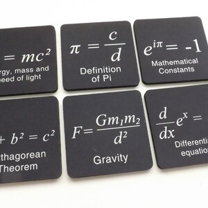 May include: Six black square coasters with white text featuring famous mathematical equations and constants. The equations include E=mc&sup2;, &pi;=c/d, e^i&pi;=-1, a&sup2;+b&sup2;=c&sup2;, F=Gm₁m₂/d&sup2;, and d/dx e^x=e^x.