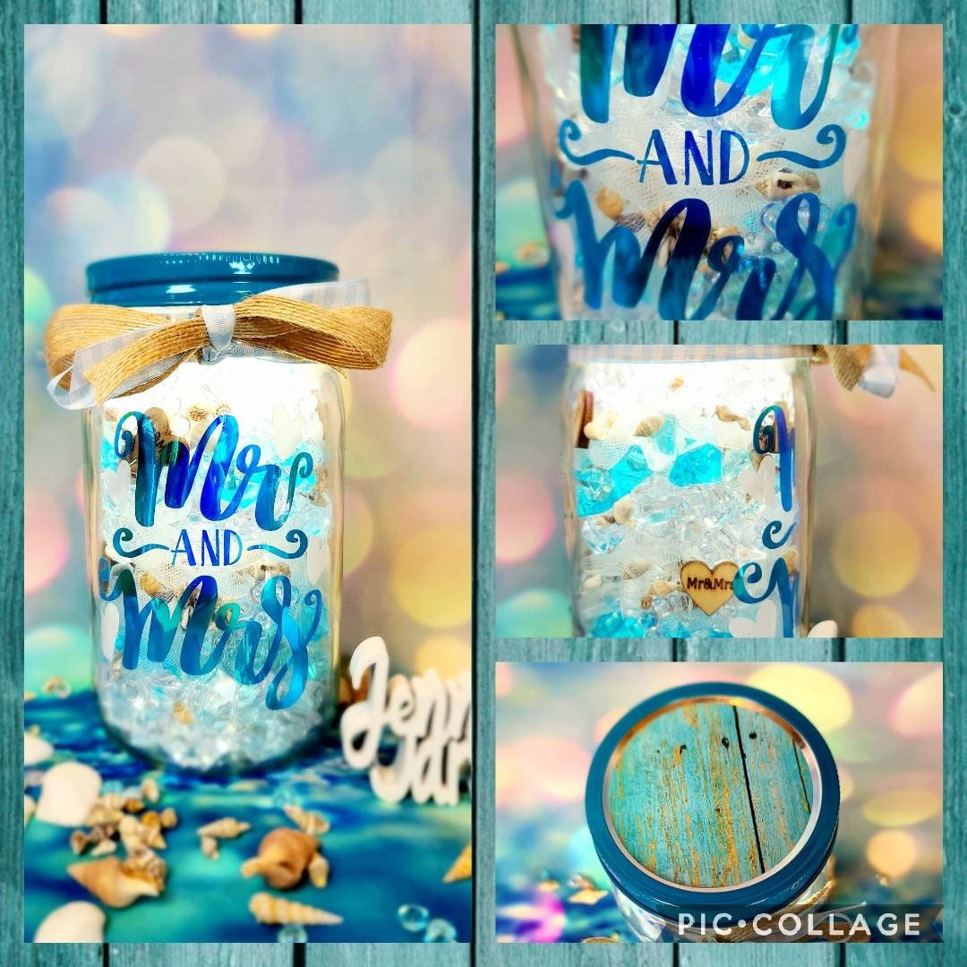 Light up your summer night with beach jar candle holders. A mismatched  group of mason jars sits atop a table. F…