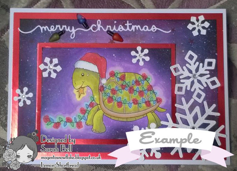 May include: A Christmas card featuring a cartoon turtle wearing a Santa hat and decorated with Christmas lights. The card has a purple background with white snowflakes and the text "merry christmas" at the top. The card also has the text "Designed by Sarah Bell" and "magentasnowflake.blogspot.co.uk Lemon Shortbread" at the bottom. The card is labeled "Example".