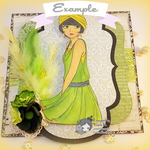 May include: A green and yellow card with a woman in a green dress and a yellow hat. The card has a white lace border and a black and white patterned background. The text "Designed by Veana R." is in the bottom right corner.