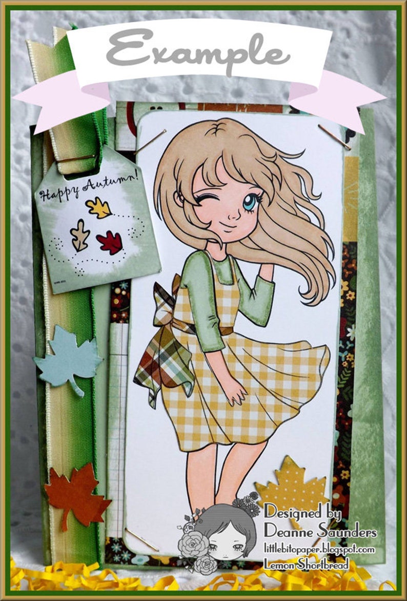 May include: A card with a cartoon girl with blonde hair and a yellow and white checkered dress. The card has a green ribbon with a tag that says "Happy Autumn!" and a green background with fall leaves. The card also has a small cartoon girl with brown hair and a floral design. The text "Designed by Deanne Saunders littlebitpaper.blogspot.com Lemon Shortbread" is at the bottom of the card.
