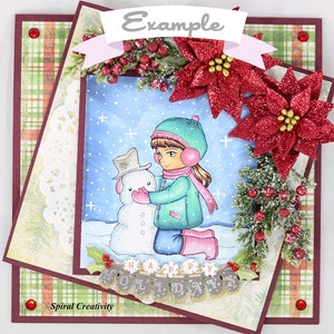 May include: A winter-themed card with a girl in a green coat and pink hat building a snowman. The card features a red plaid background, a white doily, and a banner that reads "Happy Holidays".