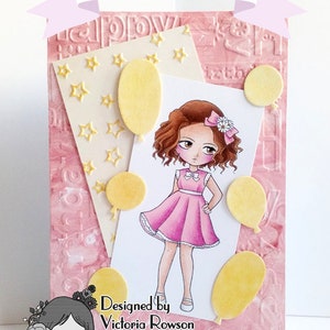 May include: A pink and white card featuring a cartoon girl in a pink dress with a white bow in her hair. The card has a yellow background with white stars and yellow balloons. The text on the card reads "Designed by Victoria Rowson" and "victorias-crafting-creations.blogspot.co.uk".