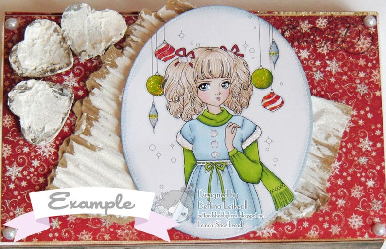 Peut inclure: Une carte blanche avec une illustration ronde d'une fille aux cheveux blonds portant une robe bleue et un pull vert. La fille tient une &eacute;charpe verte et est entour&eacute;e de d&eacute;corations de No&euml;l. La carte a un fond rouge avec un motif de flocons de neige blancs et le texte "Designed by Bettina Leikvoll" et "bettinahobbykrol.blogspot.no Lemon Shortbread!"