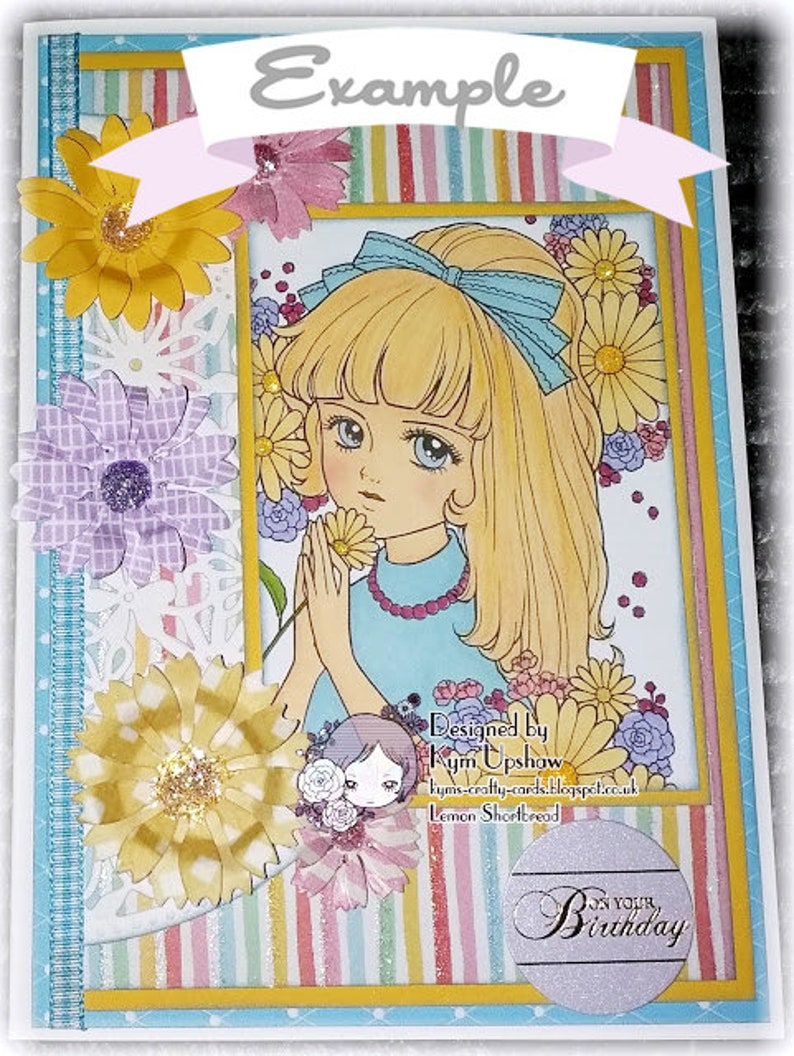 May include: A colorful card with a girl with blonde hair and a blue bow. The card has a striped background and flowers. The text on the card says "Example" and "On Your Birthday".