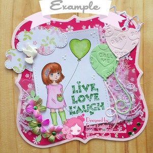 May include: A pink and white card with a girl holding a green heart balloon. The card has the words "Live, Love, Laugh" on it. The card is decorated with flowers, lace, and other embellishments.