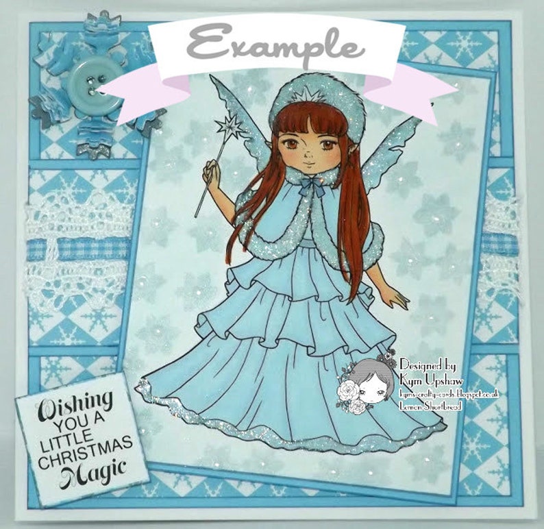 May include: A blue and white Christmas card with a snowflake design. The card features a cartoon fairy with long brown hair, a blue dress, and a wand. The text "Wishing you a little Christmas Magic" is printed on the card.