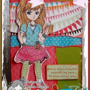 May include: A colorful card with a cartoon girl holding a drink. The card has a pink, green, and blue background with a message that says "every day I discover something new to love about you".