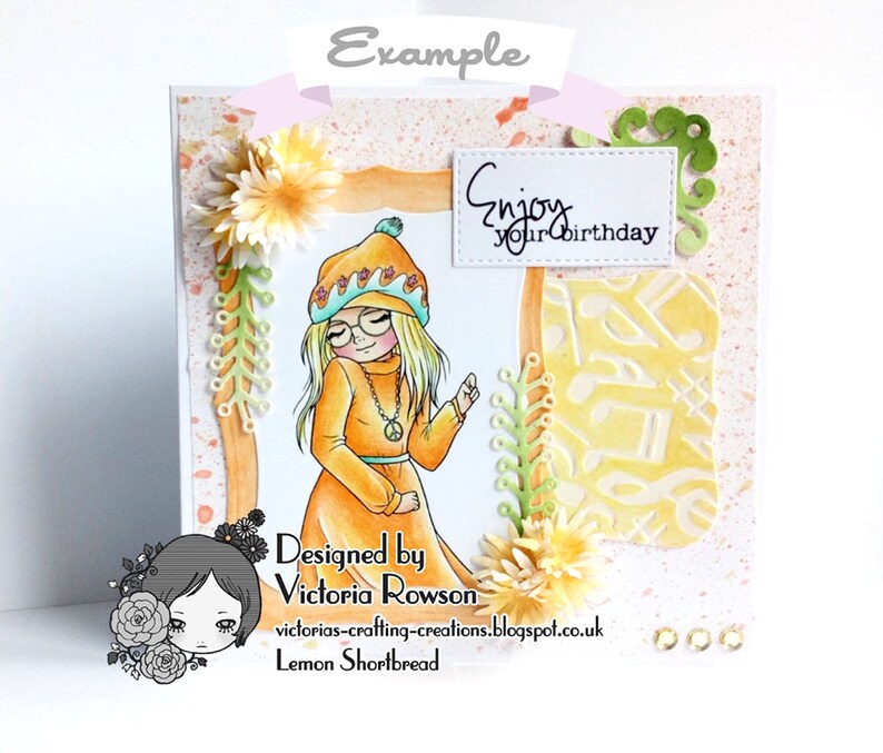 May include: A handmade greeting card with a girl wearing a yellow and orange outfit and a hat. The card has a white frame with the text "Enjoy your birthday" inside. The background is a light orange with white splatters.