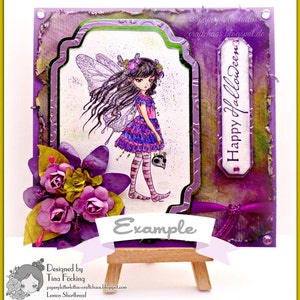 May include: A purple and green Halloween card featuring a fairy holding a skull. The card has a banner that reads "Example" and the text "Happy Halloween" on the right side. The card is designed by Tina F".cking and is called "Lemon Shortbread".