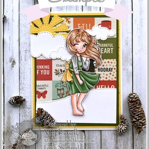 May include: A colorful card with a cartoon girl wearing a green dress and a yellow bow. The card has a patchwork design with words like "Thinking of You", "Thankful Heart", and "Hooray".