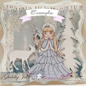 May include: A winter-themed card with a white background and a blue and white snowflake design. The card features a white deer silhouette, a fairy with blonde hair and a blue dress, and a white Christmas tree. The card has the text "Gledelig Jul" in brown lettering.