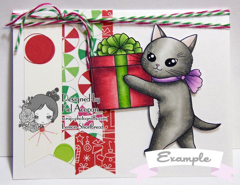 May include: A gray cat with a purple bow carrying a red and green gift box with a green bow. The background is a white card with a red and green candy cane pattern. The text "Designed by Kel Acopan scrap-photocrafts.com Lemon Shortbread" and "Example" are also on the card.