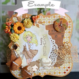 May include: A handmade birthday card with a brown frame and a yellow, white, and brown patterned background. The card features a girl with blonde hair wearing a brown dress and a white apron. The card also includes a brown bow, a gold butterfly, and a white doily. The text "happy birthday" is written in brown on the card. The card is designed by Dewi Lestari.