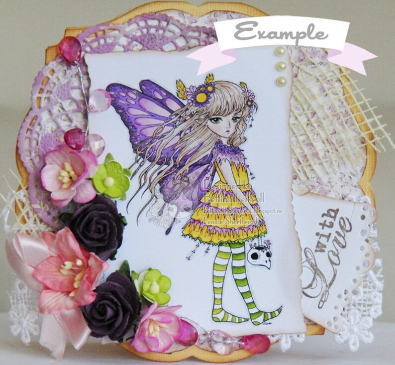 May include: A handmade card featuring a purple and yellow fairy illustration, a lace doily, and the text "Example" and "With Love".