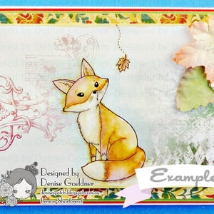 May include: A card with a watercolor illustration of a fox sitting on a white background. The fox is orange and white with a bushy tail. The card has a floral border and the text "Designed by Denise Goeldner" and "Example" on it.