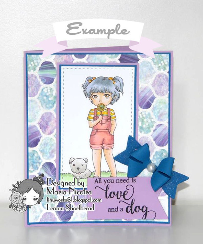 May include: A purple card with a girl and a dog on it. The girl has blue hair and is wearing a yellow and white striped shirt, pink overalls, and pink shoes. She is holding a lollipop. The dog is white and has black spots. The card has a blue bow with glitter on it. The text on the card reads "Designed by Maria Nicotra tinyworks81.blogspot.com Lemon Shortbread All you need is love and a dog".
