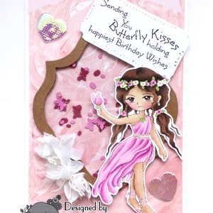 May include: A pink and brown card featuring a butterfly holding a sign that reads "Sending you Butterfly Kisses holding happiest Birthday Wishes". The card is decorated with flowers, butterflies, and glitter. The card is designed by Victoria Rowson and is called "Lemon Shortbread".