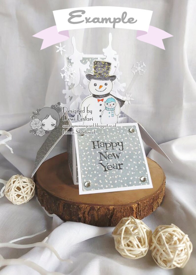May include: A pop-up card with a snowman and a smaller snowman holding hands. The card is decorated with snowflakes and the words "Happy New Year" on the front.