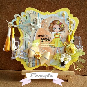 May include: Yellow and white card with a yellow frame and a cartoon girl wearing a yellow dress. The card has a bow, flowers, and a tassel. The text on the card reads "Just for You".