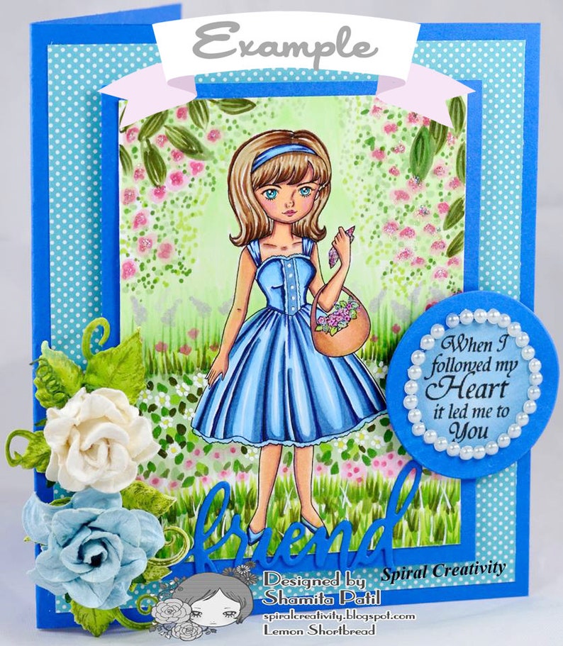 Peut inclure: Une carte bleue avec un motif de pois blancs et une bordure bleue. La carte pr&eacute;sente une illustration dessin&eacute;e &agrave; la main d'une fille en robe bleue tenant un panier de fleurs. Le texte "When I followed my Heart it led me to You" est &eacute;crit dans un cercle avec une bordure de perles. Le texte "Designed by Spiral Creativity Shamita Patil spiralcreativity.blogspot.com Lemon Shortbread" est &eacute;crit en bas de la carte.