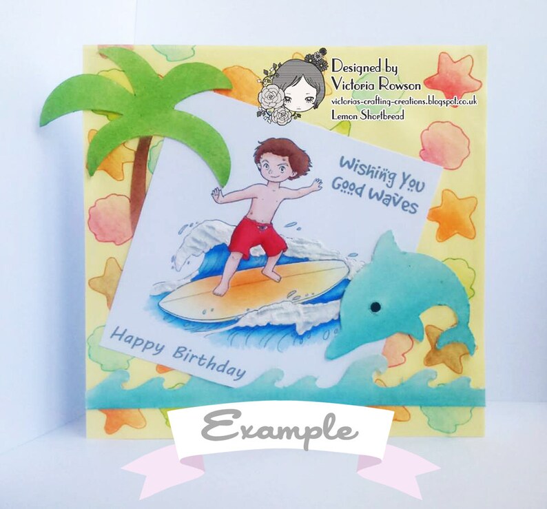 May include: A birthday card with a cartoon illustration of a boy surfing on a wave with a dolphin jumping out of the water. The card has a yellow background with a palm tree, seashells, and starfish. The text on the card reads "Wishing You Good Waves" and "Happy Birthday".