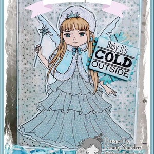 May include: A blue and white winter fairy card featuring a girl wearing a blue dress and a white fur-trimmed cape. The card has a banner that says "Baby it's COLD OUTSIDE".