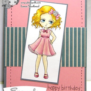 May include: A pink birthday card featuring a cartoon girl in a pink dress with a flower in her hair. The card has a grey border and the text "happy birthday!" and "Example" on it.