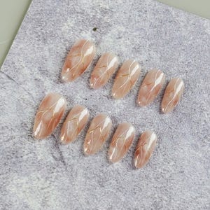 Refined Almond Press On Nails in Soft Pink Gradient with White and Gold Lines, Floral Designs and Pearl Details, Fake Nails for Dates