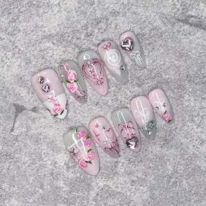 Exquisite Almond Press-On Nails with Soft Pink Floral Designs, Heart Details, and Rhinestones, Ideal for Romantic Dates and Feminine Party