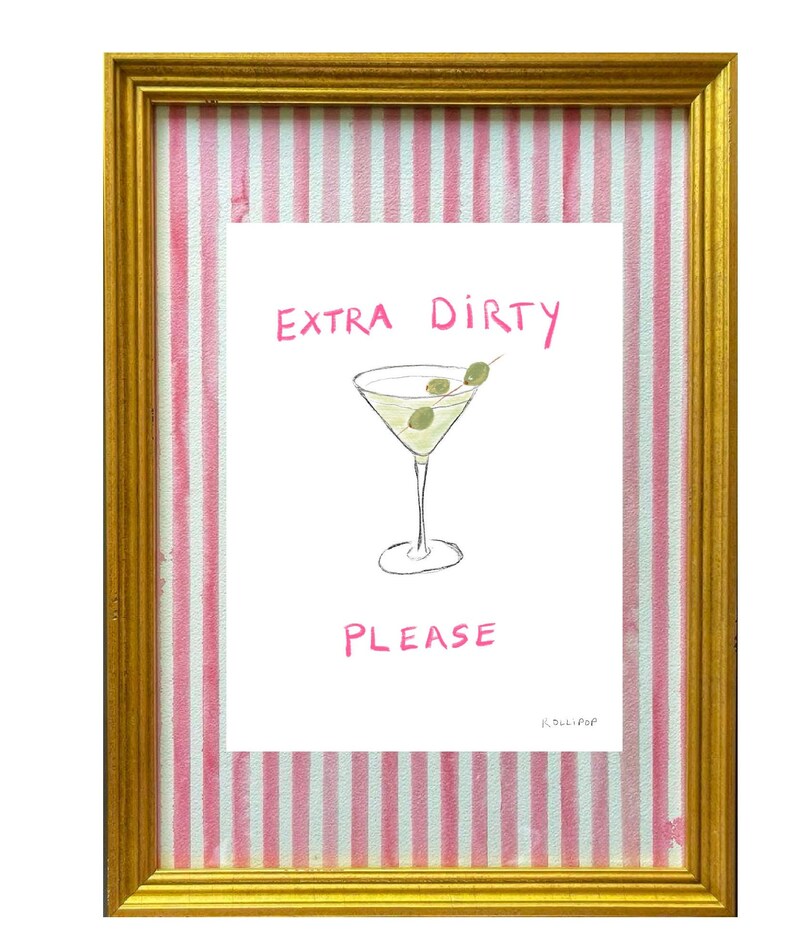 May include: A framed print with pink and white stripes on the mount. The print features a hand-drawn illustration of a martini glass with olives and the text "EXTRA DIRTY PLEASE" in pink.