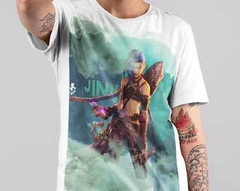 May include: A white short-sleeved t-shirt featuring a graphic print of a blue-haired character with long braids, wearing dark clothing and holding a weapon. The background of the print has teal watercolour splashes and the text JINX.