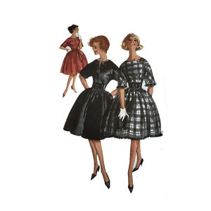 May include: Three women wearing different styles of dresses. The woman on the left is wearing a red dress with a white collar. The woman in the center is wearing a black dress with a white collar and a belt. The woman on the right is wearing a black and white plaid dress with a white collar and a belt.