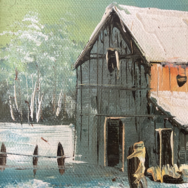 May include: Oil painting of a winter landscape featuring a weathered wooden barn with a snow-covered roof. The barn is painted in shades of gray and brown, with a small window. A fence and trees are in the foreground, with a snowy ground.