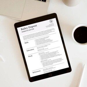 May include: A black and white CV on a tablet screen. The CV is for Bailey Dupont, Website Editor. The CV lists skills, education, work experience, and references.