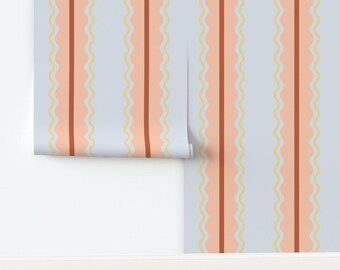 May include: Wallpaper roll with a repeating vertical pattern. The design features alternating stripes of light peach, dark brown, and pale yellow wavy lines against a light blue background. The roll is partially unrolled, revealing the pattern.