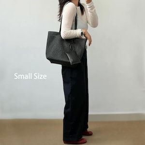 May include: Black woven tote bag with a matching small pouch. The bag has a rectangular shape with a structured design and long handles. The text "Small Size" is visible on the left side of the image.