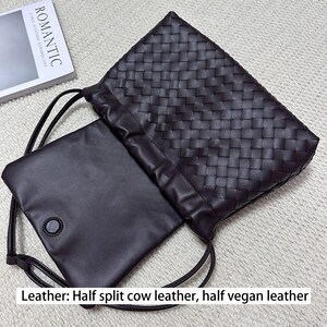 May include: A dark brown leather drawstring bag with a woven pattern. The bag is open, revealing a smooth, dark brown interior pouch with a button closure. The text "ROMANTIC" is visible on a book in the background. The bag is made of half split cow leather and half vegan leather.