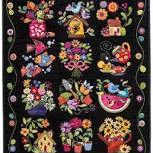 May include: A colorful, handcrafted quilt with a black background. The quilt features various appliqued designs, including flowers, birds, birdhouses, watering cans, and small houses. The border is a black and yellow wavy pattern.