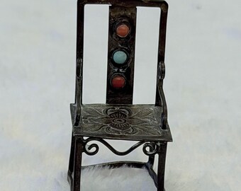 Primitive doll chair with intricate details on the seat and blue and
