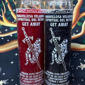 May include: Two glass jar candles, one red and one black, with white text and graphics. The candles have the words "MISTICAS", "MARAVILLOSA VELADORA ESPIRITUAL DEL RETIRO", and "GET AWAY". A sword graphic is also visible.