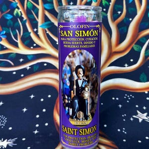 May include: A purple glass candle with the text "SAN SIMÓN" and "SAINT SIMON" in gold lettering. The candle features an image of a man in a black suit and hat. Text on the candle includes phrases in Spanish and English.