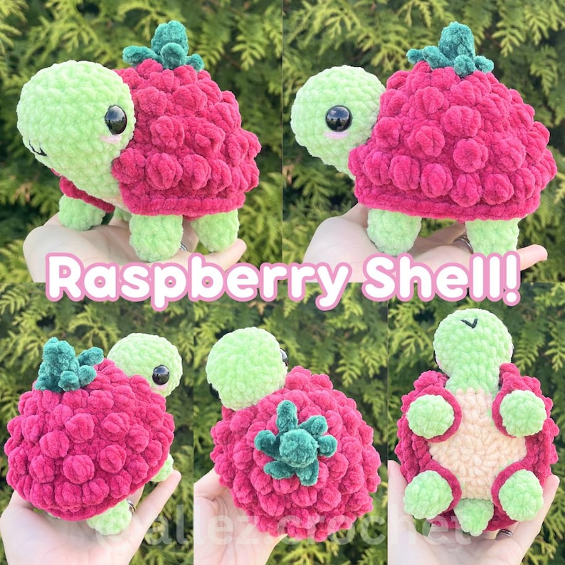 May include: A crochet turtle plush toy featuring a light green head and limbs with a textured, dark pink raspberry-shaped shell topped with a small green leaf. The shell has a bumpy, berry-like surface. The text Raspberry Shell! is visible.